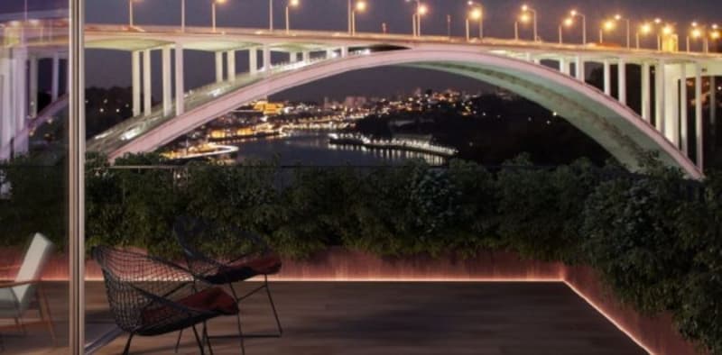 Terrace with chairs and plants, balcony railing, cityscape, bridge