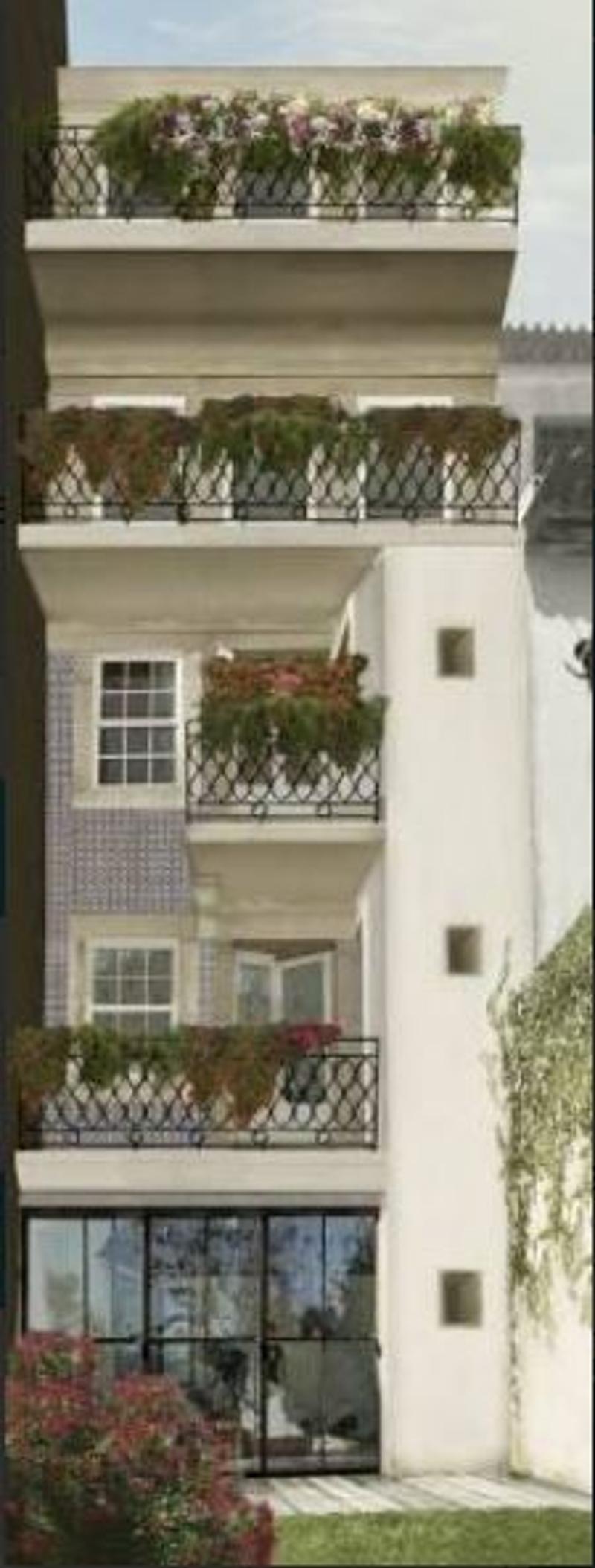 Multi-story building with balconies, flower boxes, and decorative railings.