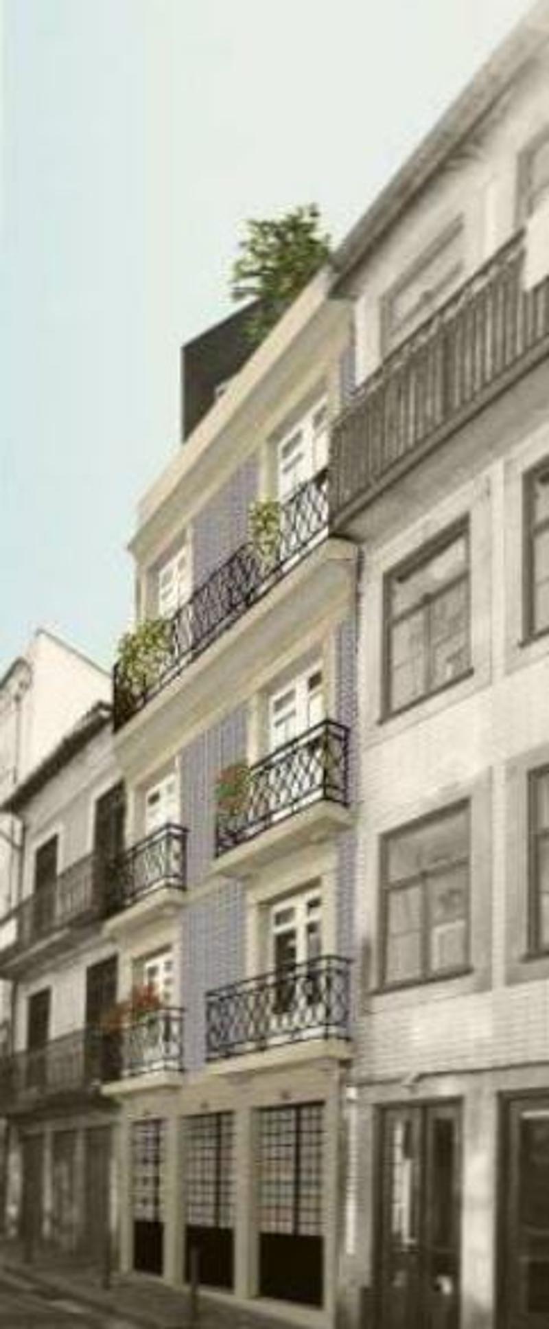 Multi-story building with balconies, ornate architectural details, and greenery on the balconies.