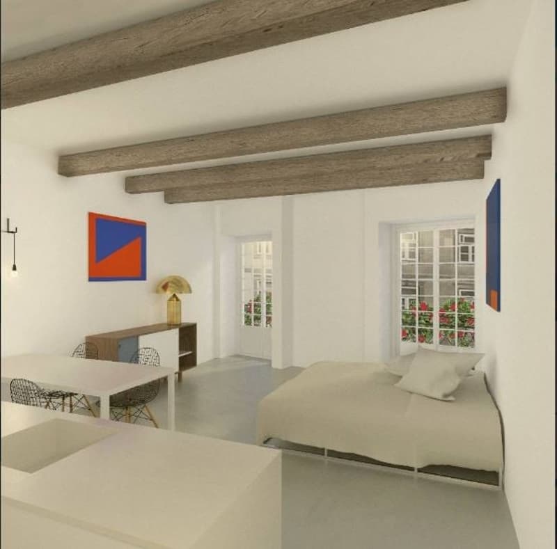 Open concept living space with exposed wooden beams, white walls, large windows, modern furniture including a sofa, coffee table, and dining table