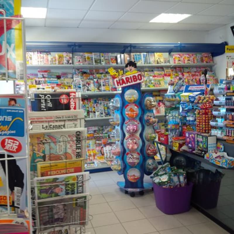 Candy store with magazines, shelves with candy and toys, candy dispenser, counter with candies, magazines rack