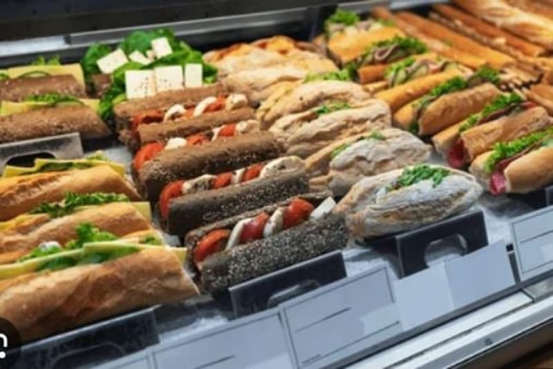 Sandwiches and baguettes, with various toppings such as lettuce, tomato, cheese, and different meats.