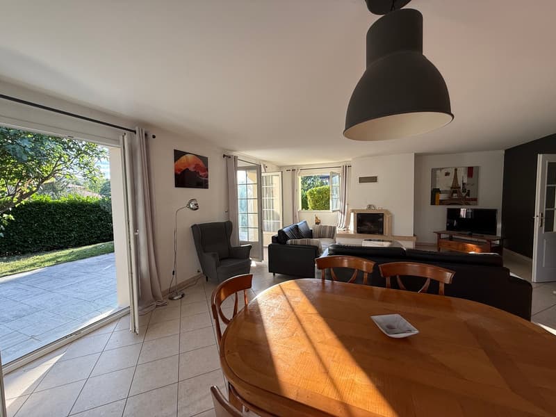 tiled floor, dining table, sofa, armchair, TV, lamp, fireplace, sliding doors leading to terrace