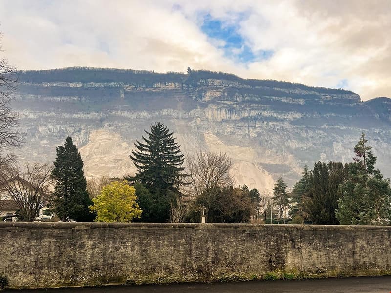 A panoramic view of a mountain cliff and a town landscape