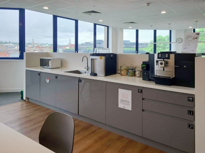 Commercial kitchen with appliances, sink, refrigerator, microwave, view of city