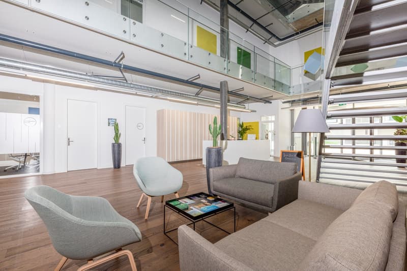 modern interior, gray sofa, round table, lamps, wooden floors, glass railings, office chairs, potted plants