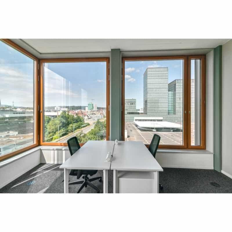 office room with white desks and chairs, large windows with city view