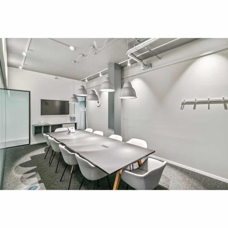 large room, long table, glass partitions, overhead lighting, desk, television