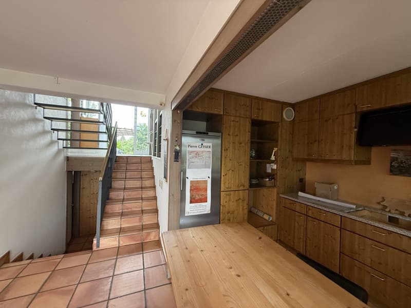 staircase, wooden cabinets, granite countertop, refrigerator, natural light