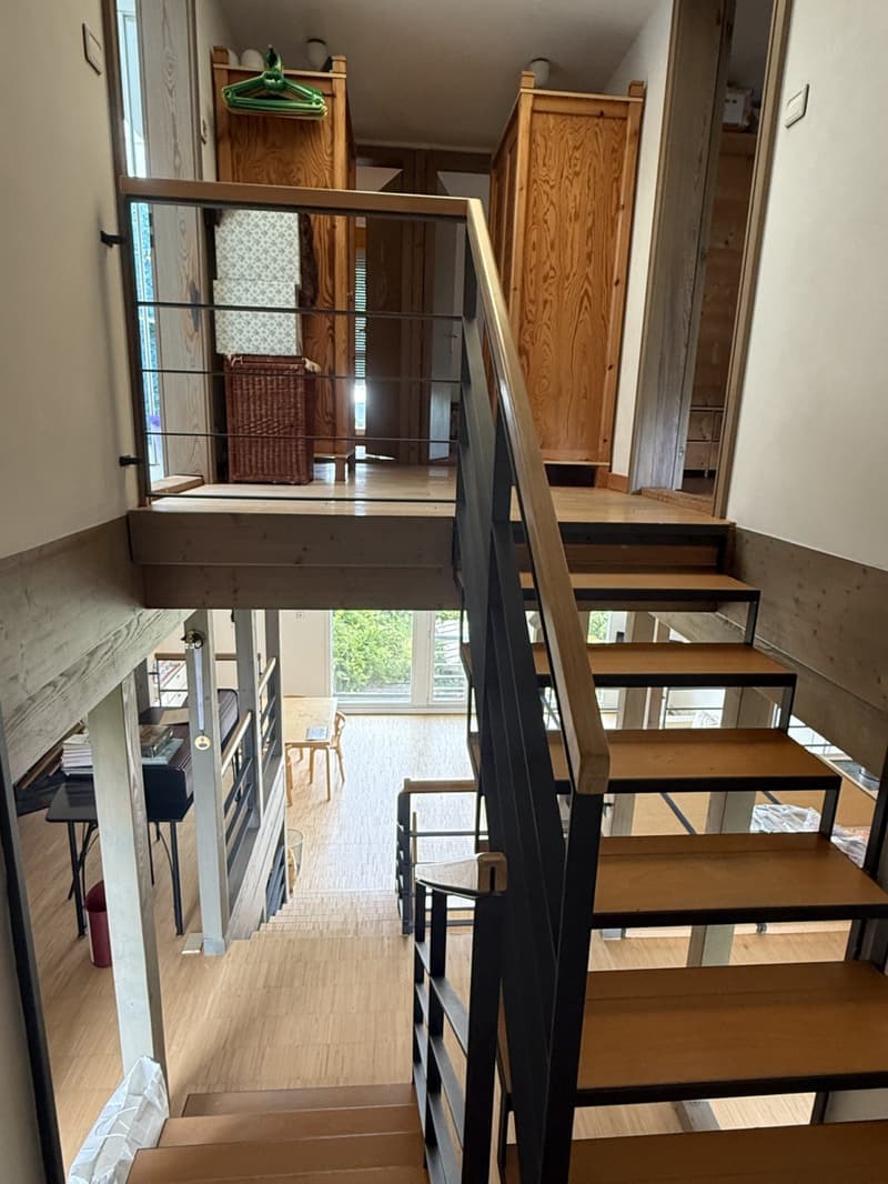 elevated wooden ground floor, wooden staircase, large windows