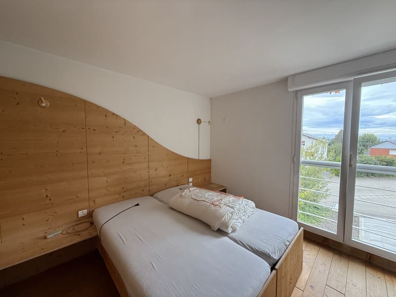 wooden bed, white linens, pillow, nightstands, lamps, sliding glass doors, balcony, view of the outside