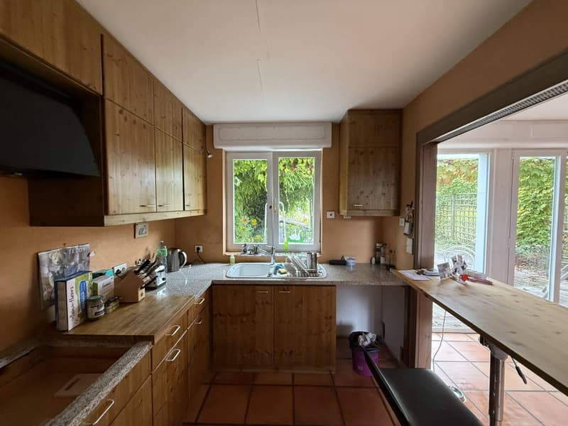 open kitchen, large window, granite countertops, wooden cabinets, sink, gas stove