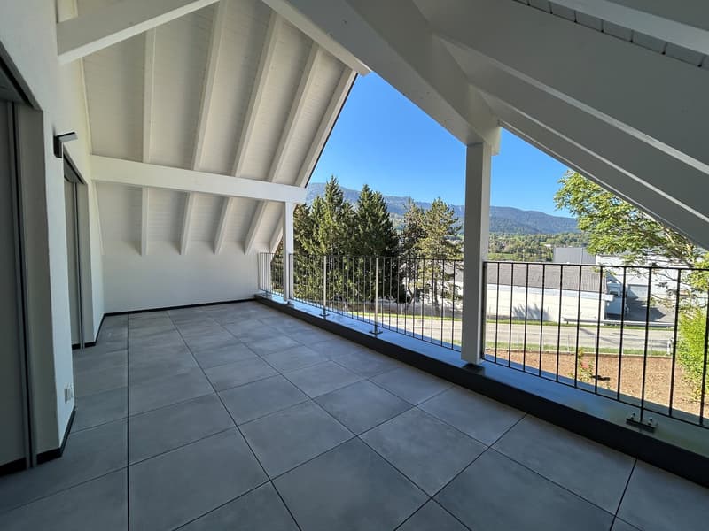 empty room, tiled floor, white walls, balcony with metal railings, sloped roof