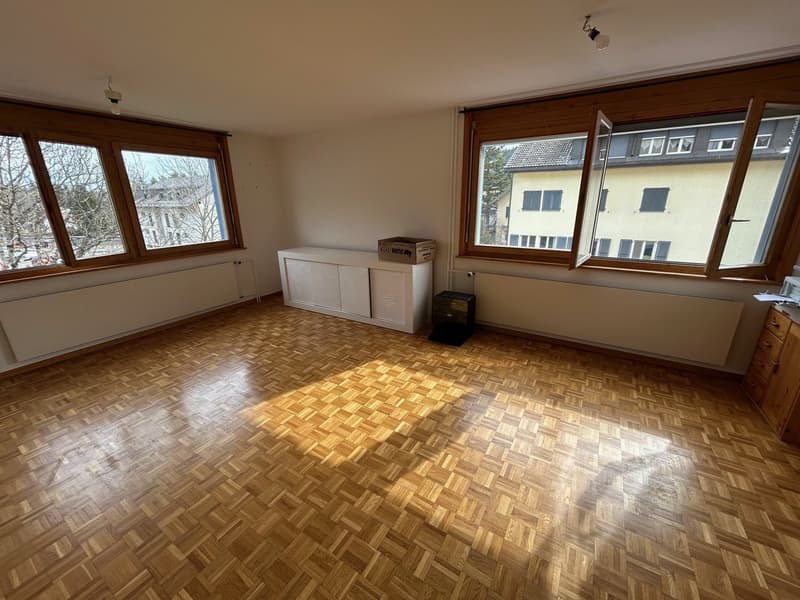 empty room, wooden parquet floor, large windows, white cabinets, radiators, wooden cabinet