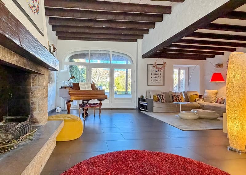 large fireplace, view to the outside, couch, table, piano, carpet