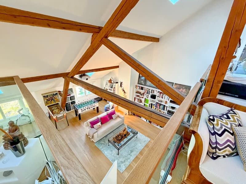 modern wooden loft style house, sofa, glass coffee table, wooden beams, glass railing, bookshelves, foosball table