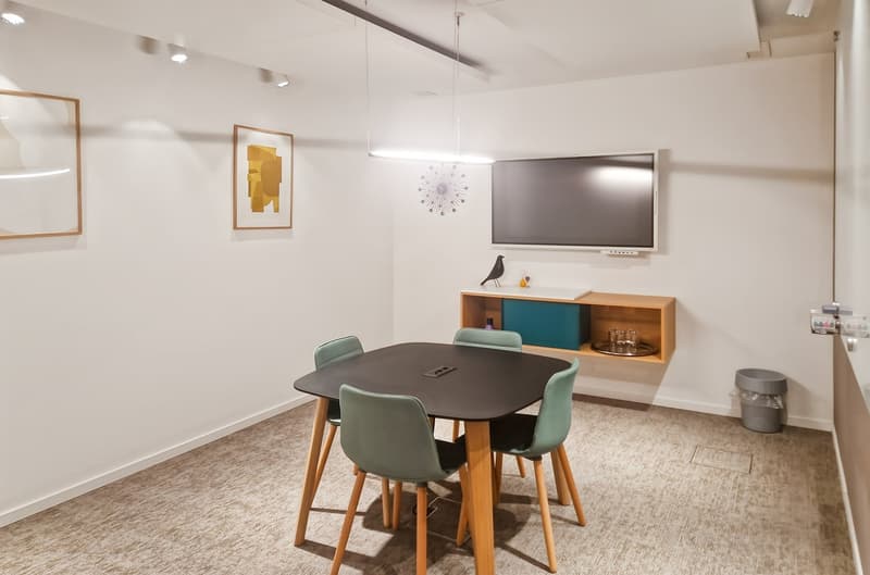 modern furnished room with a table and four chairs, a mounted TV, wall art, and a shelf