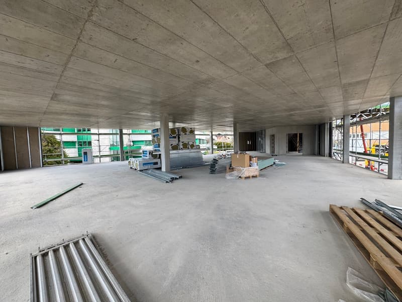 unfinished room, concrete floor, metal beams, construction materials