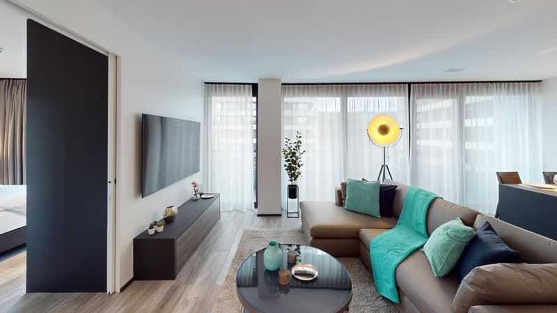 modern living room with brown sofa, glass coffee table, TV, white curtains