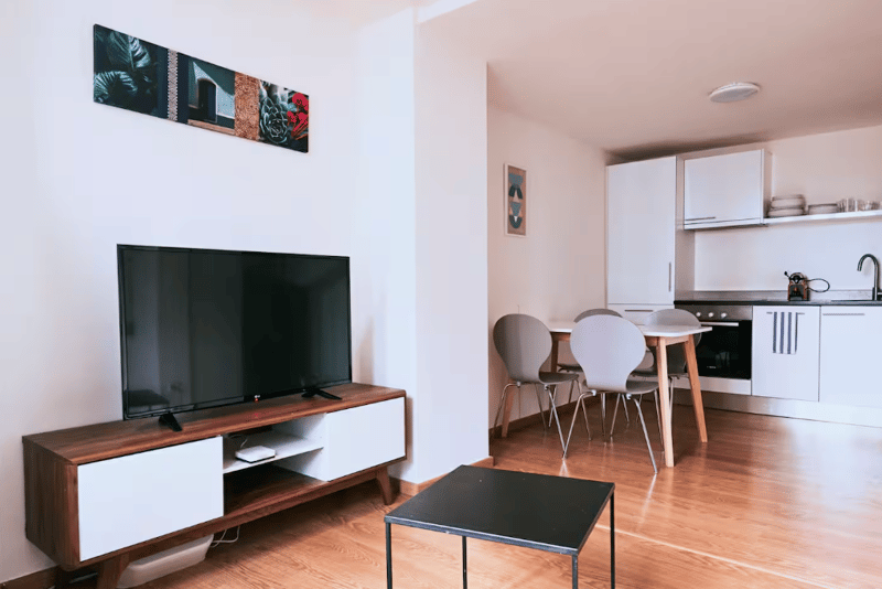 TV, entertainment center, dining area, wooden floor