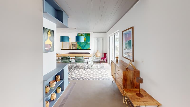 modern open plan living room, hallway and dining room. Wooden tables, chairs and shelves, bright white walls, modern furnishings, abstract wall art, indoor plants