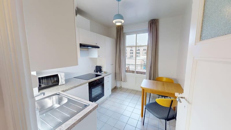 Modern kitchen, with a stove, oven, microwave, sink and table.