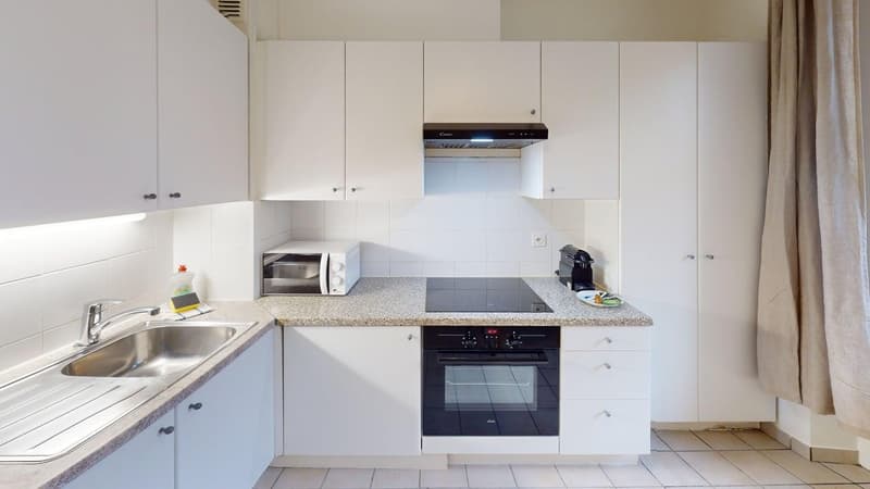 modern kitchen with integrated appliances and cabinets, marble countertop, electric stove, microwave, sink, dishwasher, kitchen island, open cupboards, tiled flooring