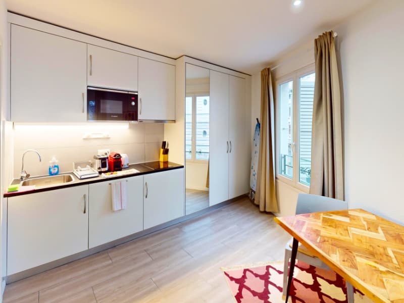 kitchen with countertop, sink, microwave, cabinets, toaster, coffee maker, rug, desk, chair, window, curtains