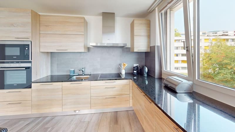 modern kitchen with wooden cabinets, granite countertops, stainless steel appliances, large window with city view