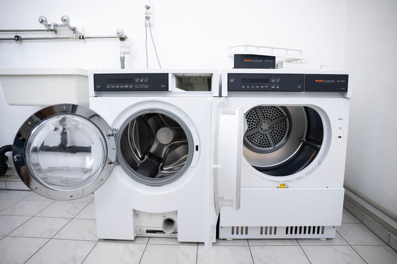 Washing machine, dryer, and dishwasher in a laundry room setting