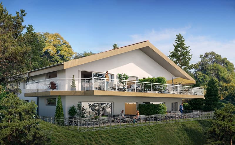 Two-story modern house with a large balcony/terrace, surrounded by lush greenery and trees. The house has a sleek, angular design with large windows and a neutral color scheme. There are people visible on the balcony, suggesting it is a residential proper