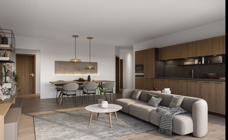 Open-concept living room and kitchen with wooden cabinetry, black countertops, pendant lighting, dining table with chairs, and a gray sectional sofa with throw pillows and blanket