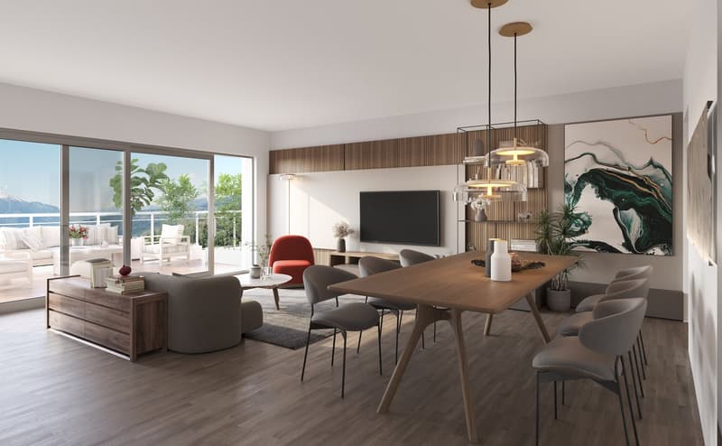 Spacious open-plan living and dining area with large windows offering a scenic view. The living room features a comfortable sofa set, a TV, and decorative artwork on the wall. The dining area has a wooden table with chairs, and the room is illuminated by