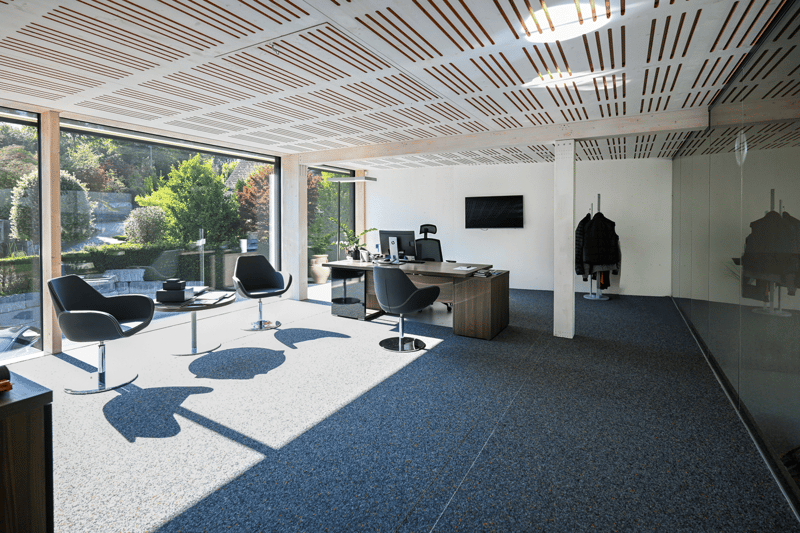 Contemporary office with large windows, modern furniture, desk with computer, chairs, glass wall