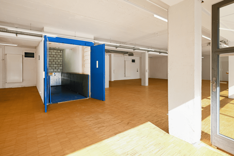 Empty room, wooden floors, raised ground floor, sliding door, white walls, bright lighting