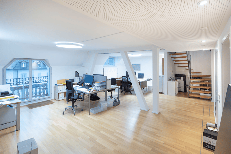 modern office, wooden floor, white walls, glass door, office desks, chairs, monitors, printers, storage boxes, staircase