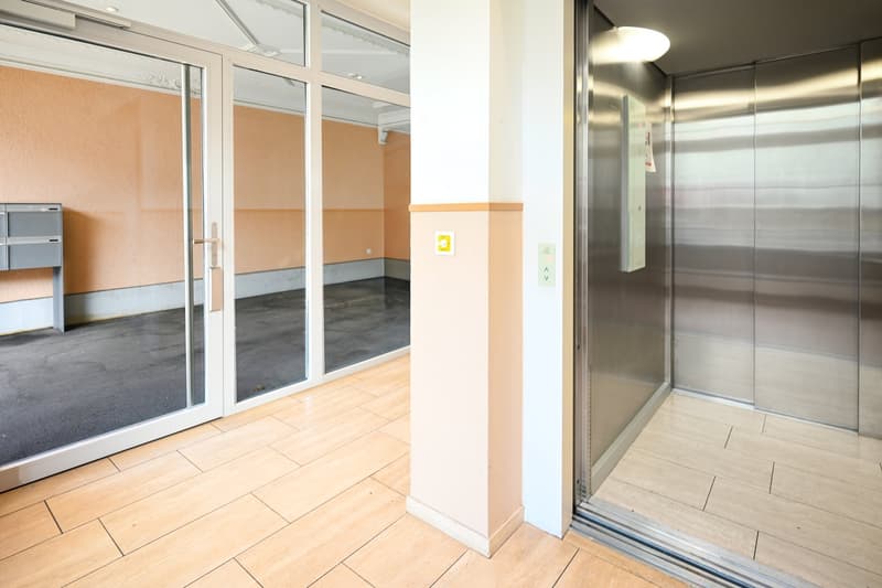 elevator, glass doors, wooden floor, mailbox