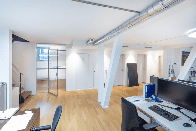 wooden floor, white walls, glass door, white cabinets, desk, computer, chair