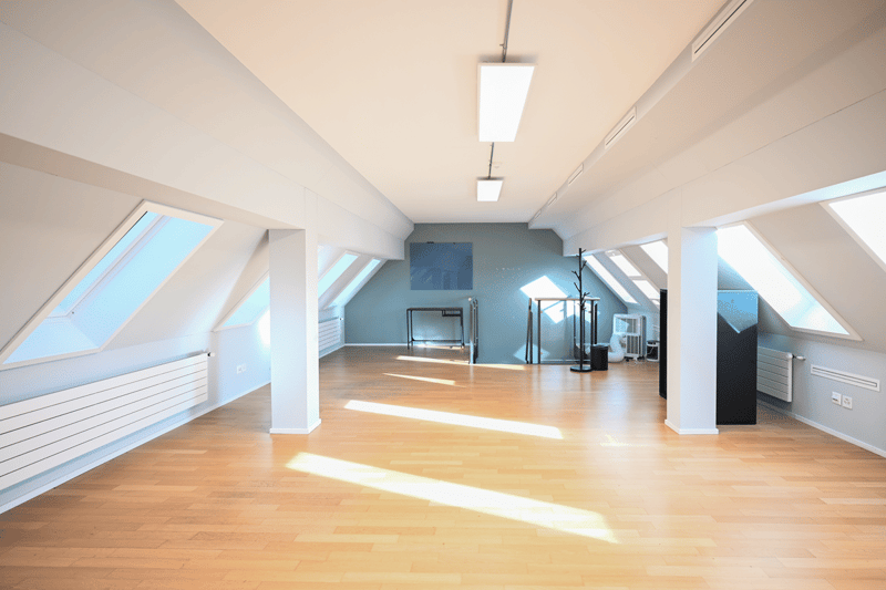 empty room, wooden floor, white walls, ceiling lights, windows, radiators