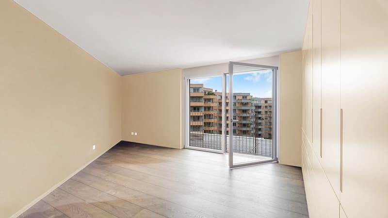 empty room, wooden floor, glass door leading to terrace, windows, beige wall, power outlet
