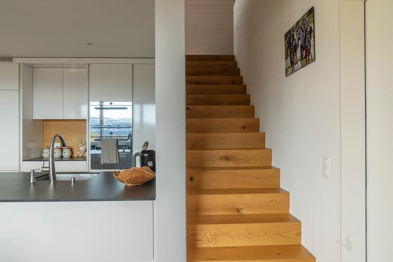 Modern kitchen, raised ground floor, white cabinets, wooden stairs, modern fittings