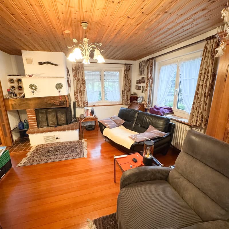 living room, fireplace, chandelier, couch, sofa, coffee table, wooden floor, radiator