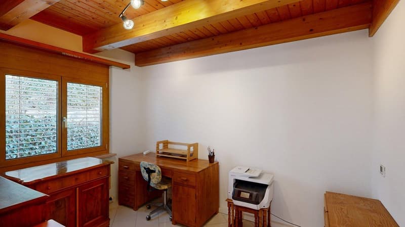 room with wooden desk, white wall, window with blinds, wood floor, wooden ceiling, printer, small shelf, office chair, wooden drawers