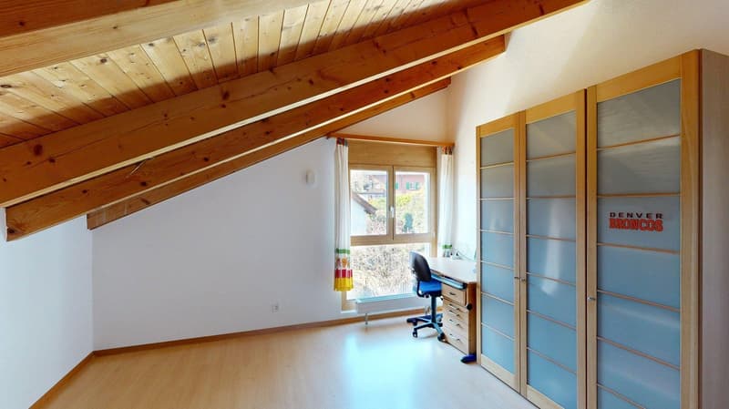 empty room, wooden ceiling beams, wooden floor, desk with chair, glass window, curtains, closets