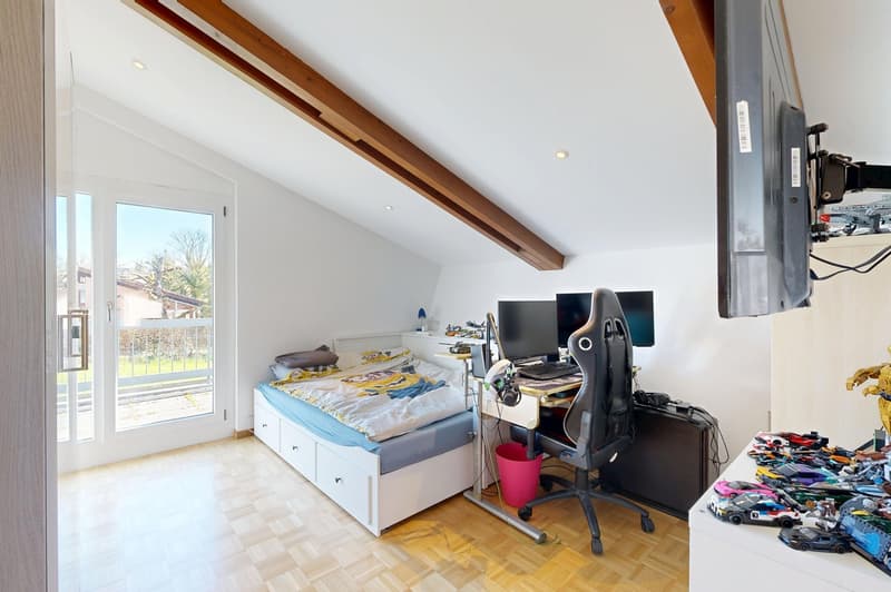 bedroom with bed, desk, chair, monitor, toys, wooden floor, glass door, balcony