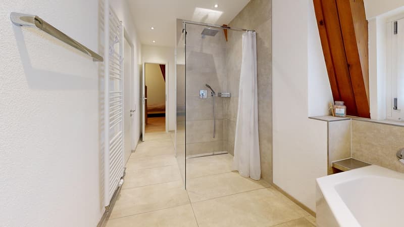 modern bathroom with glass shower, bathtub, white tiles, wooden ceiling, towel rack