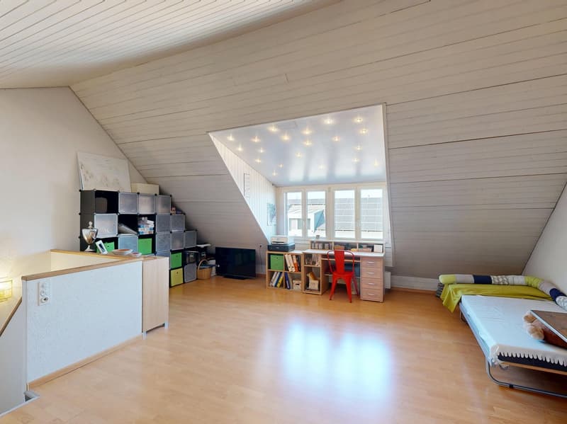 attic room with wooden floor, white walls, desk, chair, bed, shelves, window, ceiling lights