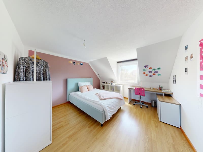 Bedroom with bed, desk, chair, wardrobe, and pink wall