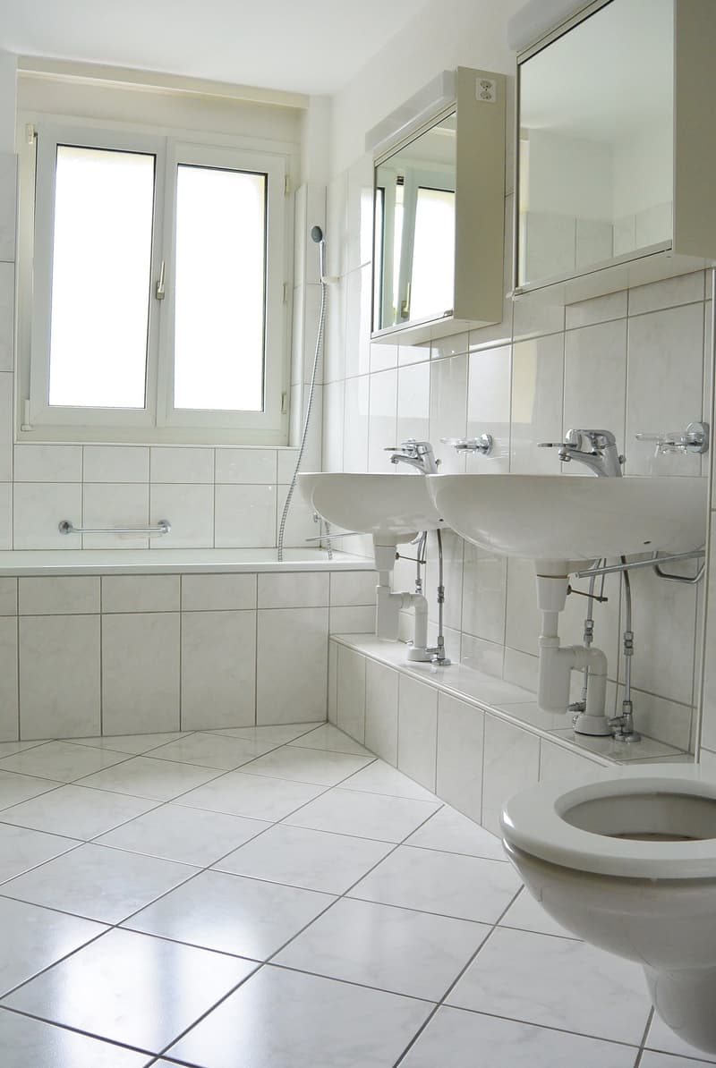 Bathroom: bathtub, sink, mirror, tiles, toilet, faucet, power outlet