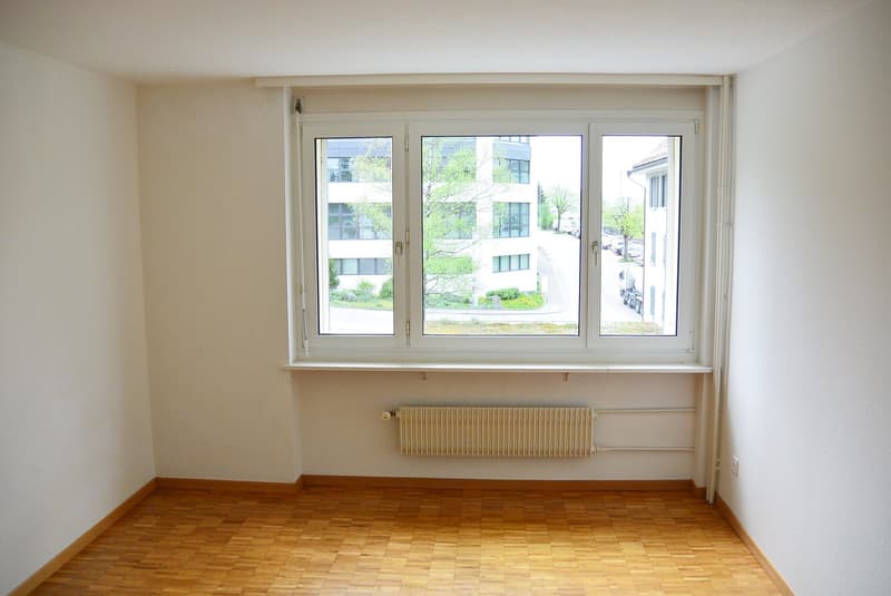 empty room, large window, radiator, wooden floor